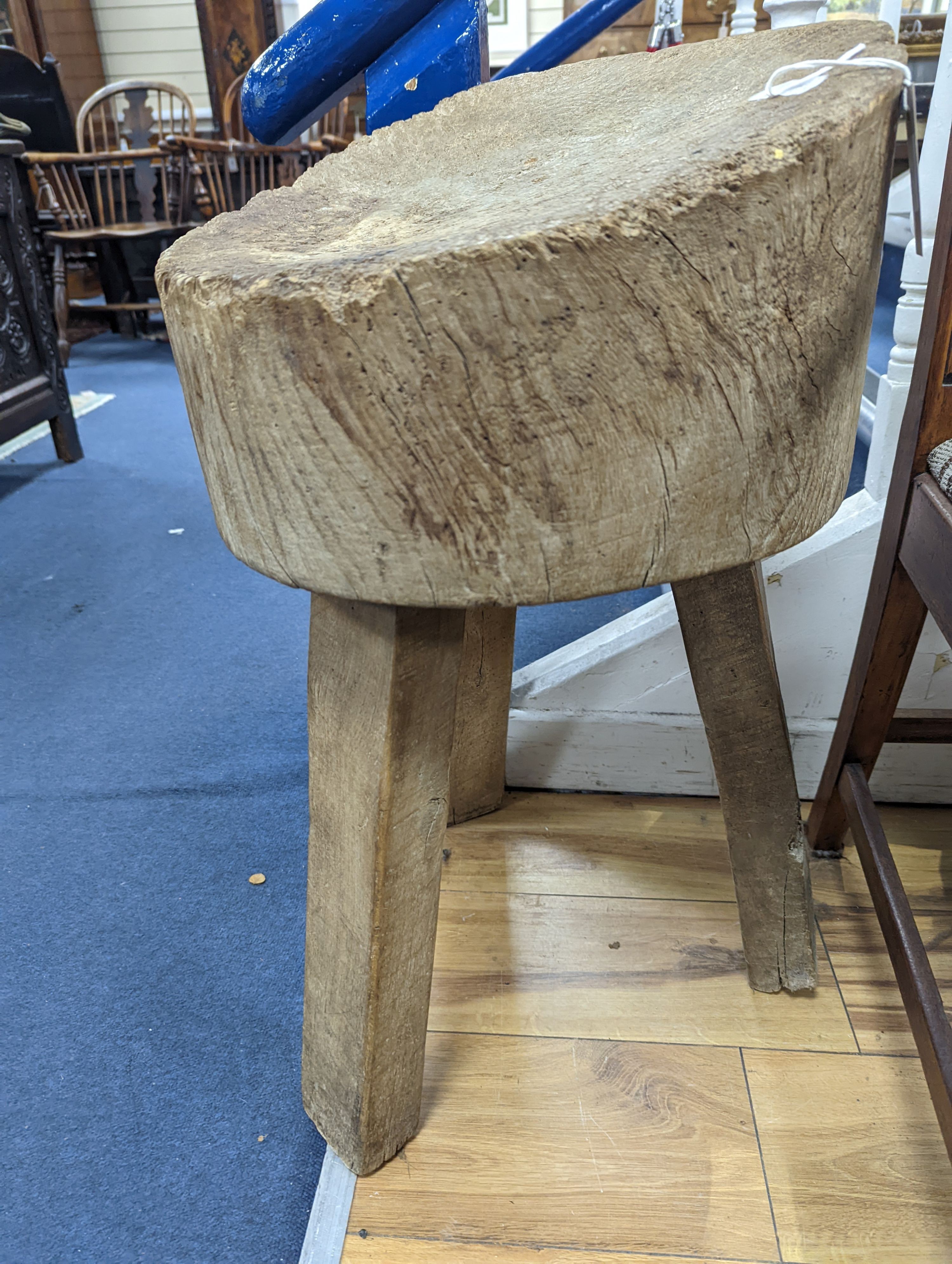 A three-legged provincial chopping block, height 70cm